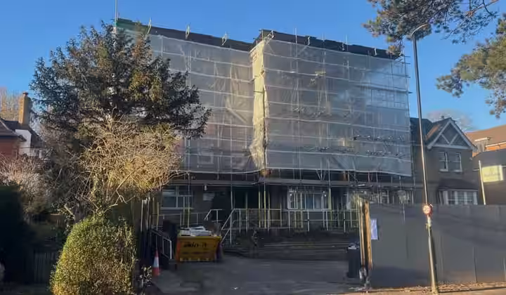 Large scaffold structure with protective sheeting